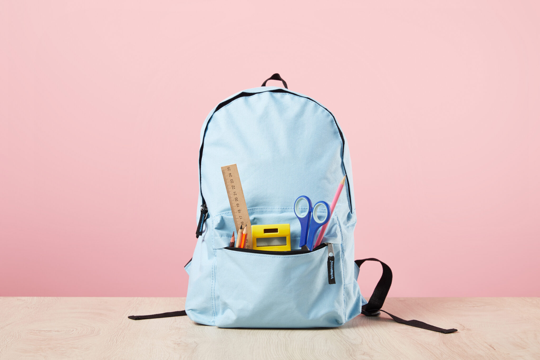 school blue backpack with stationery in pocket