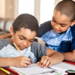 two young brothers working on homework together